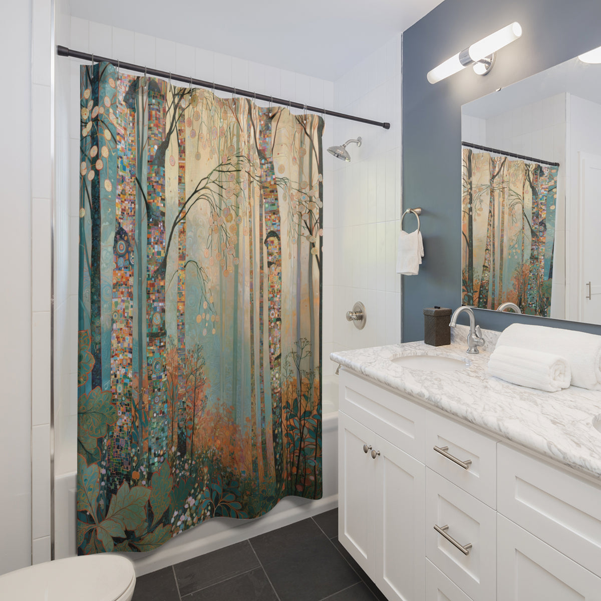 A forest-themed shower curtain with a detailed print of trees and foliage in muted teal, brown, and gold tones, hanging in a modern white bathroom with a marble countertop and dark gray tile floor.