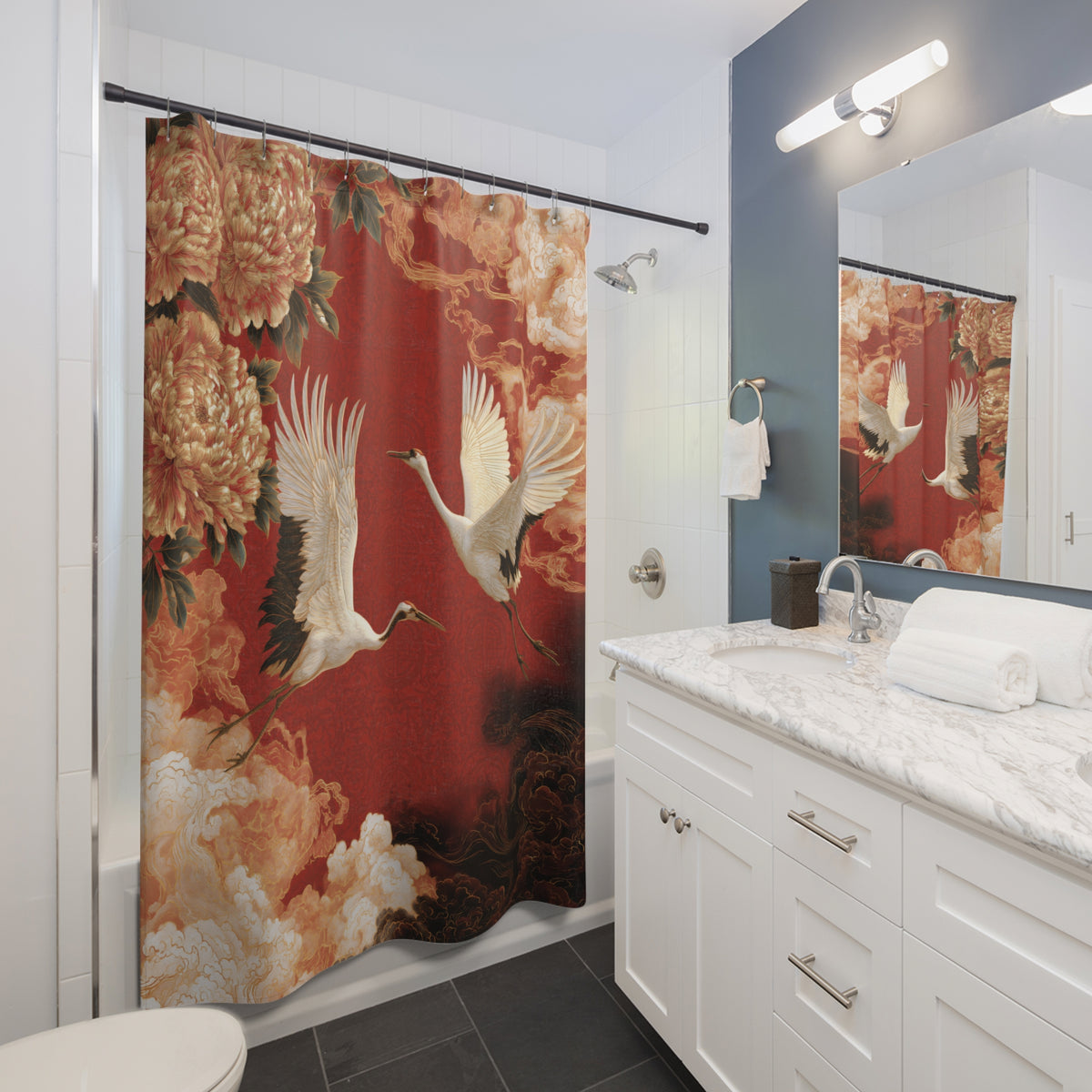A shower curtain featuring a red background with white cranes and large beige floral motifs, hanging in a modern bathroom with a white vanity, marble countertop, and mirror.