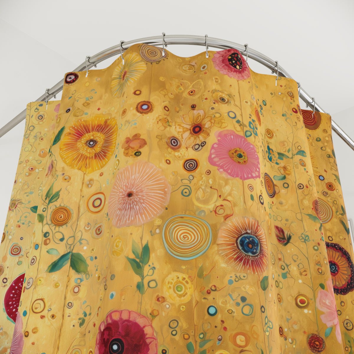 A yellow shower curtain with a colorful retro floral and circular pattern, hanging from a curved metal rod against a plain white wall.