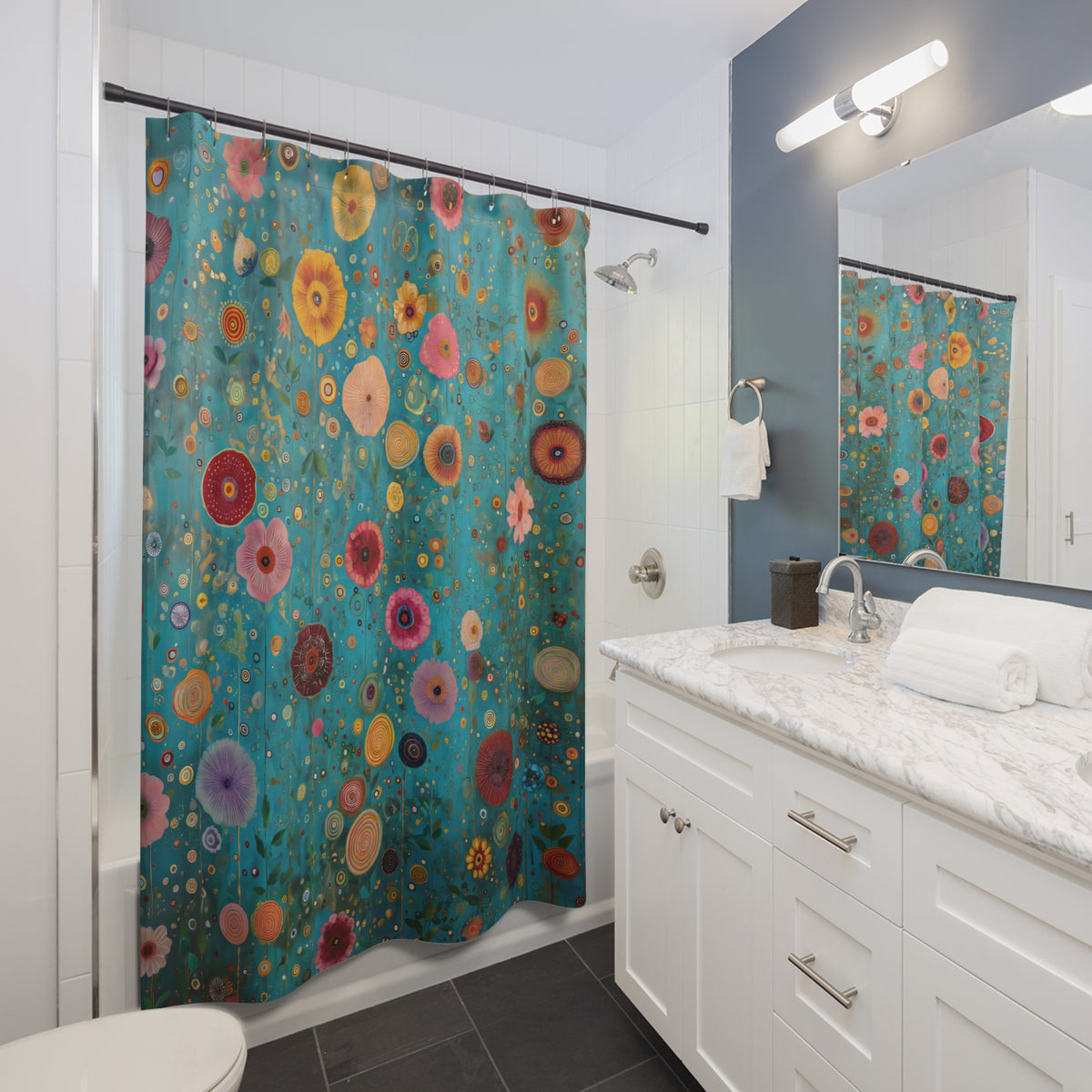 A colorful shower curtain with a vibrant floral pattern in teal, pink, orange, yellow, and red, hanging in a modern white bathroom with a marble vanity and mirror.