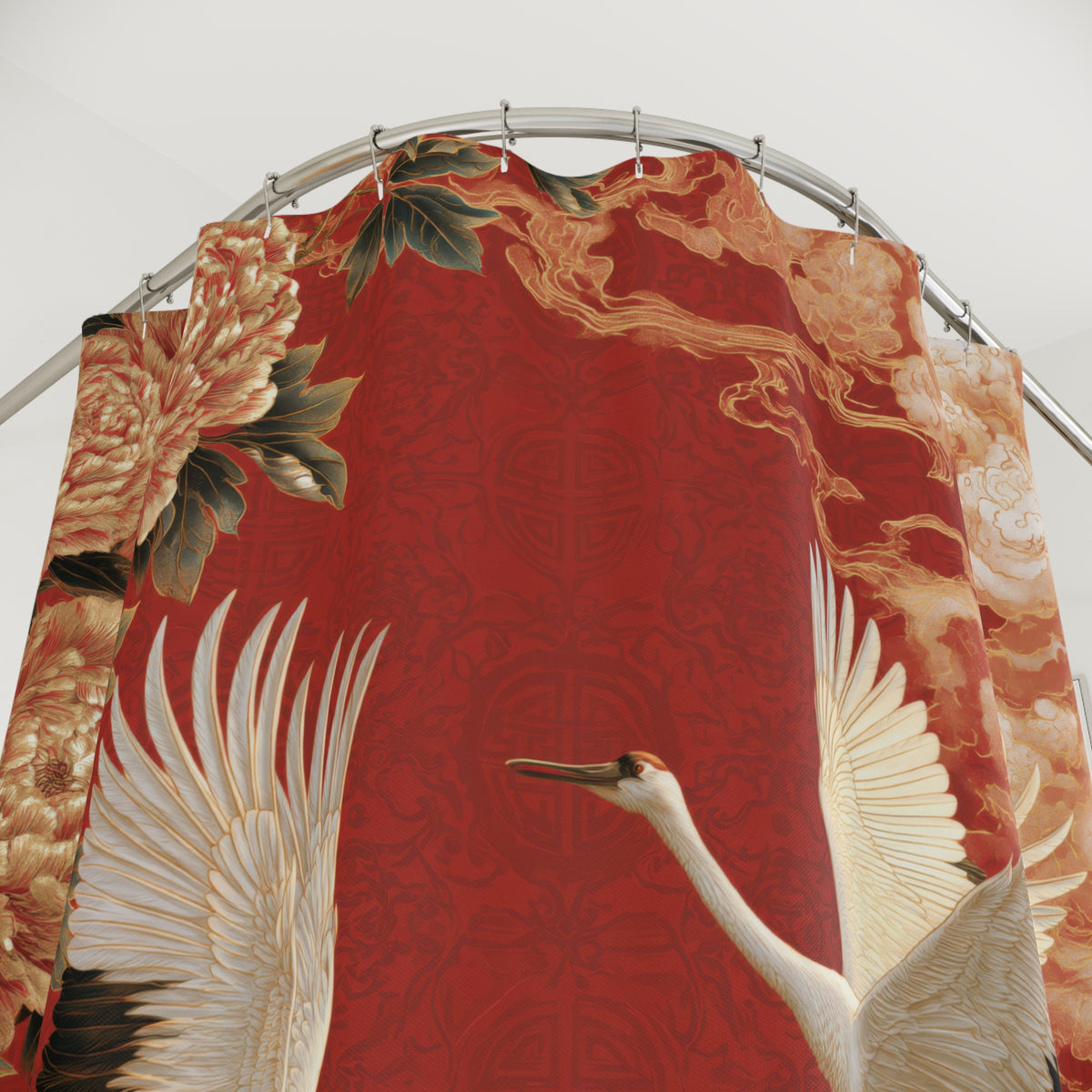 A decorative red curtain or drape hanging from a curved metal rod, featuring a large white crane, peach flowers, green leaves, and gold cloud motifs on a red patterned background.