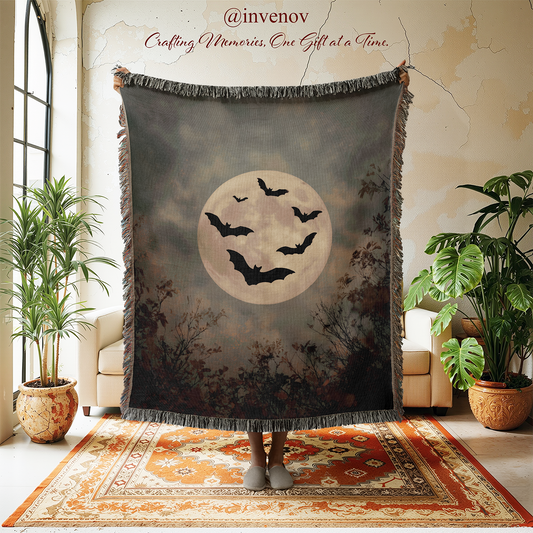Halloween-themed blanket with bats and moon displayed in a room with plants and furniture.