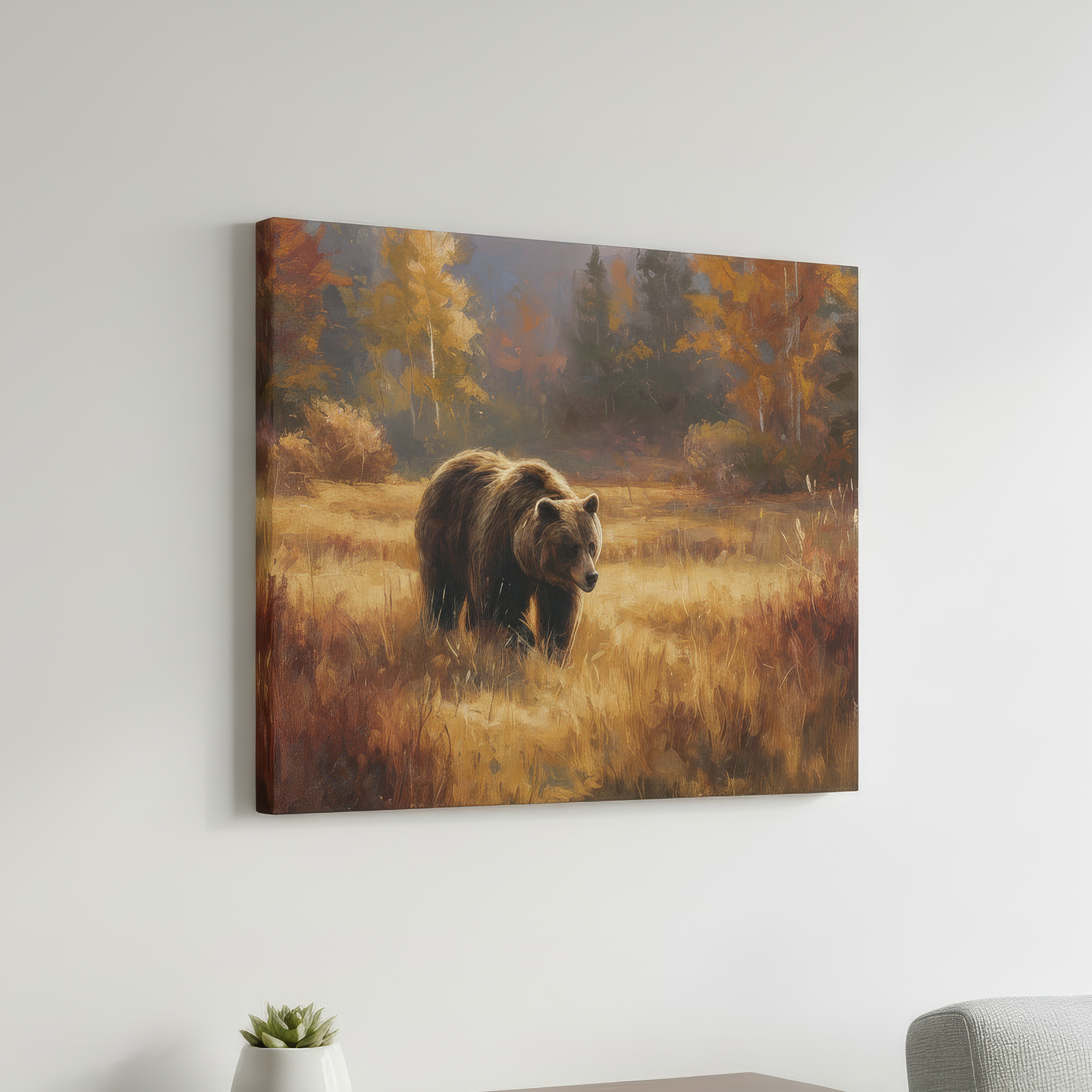 Canvas print of a bear in a field hanging on a wall above a wooden shelf with a plant and a gray chair.