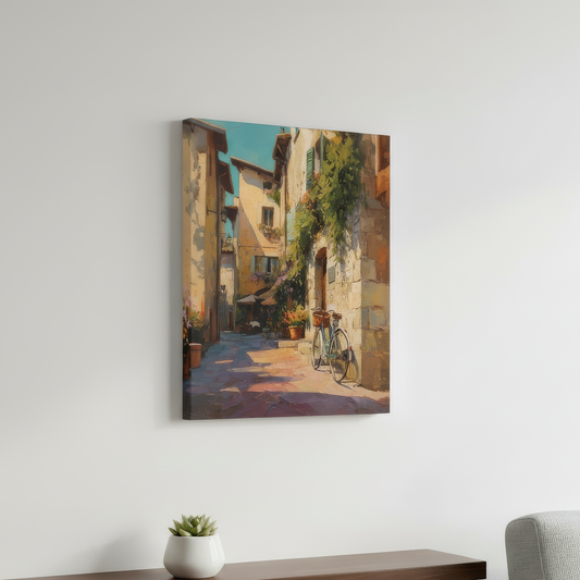 Canvas print of a street scene with a bicycle hanging on a white wall above a wooden shelf with a plant.