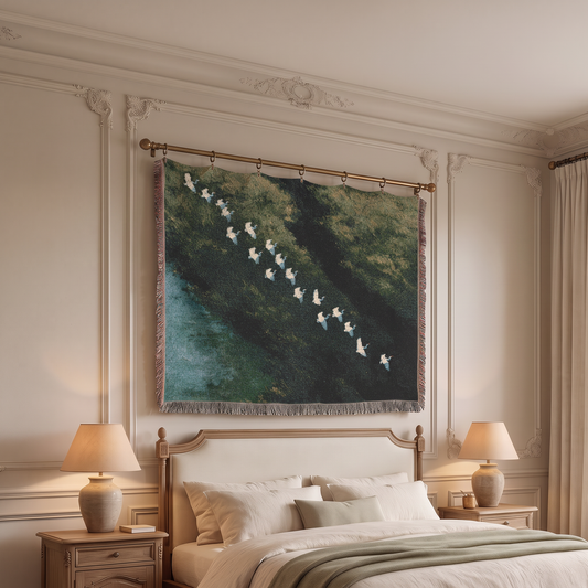 A large woven wall tapestry featuring a forest scene with a flock of white birds, hanging on a gold rod above a bed in a beautifully decorated bedroom.