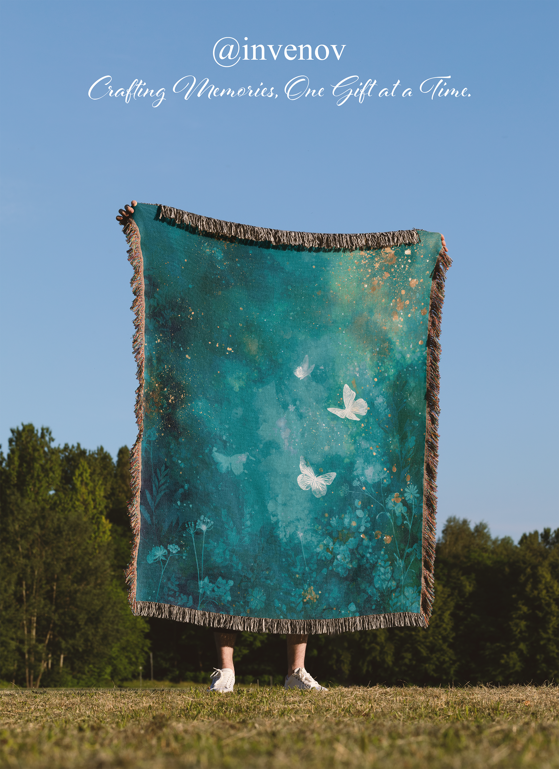 Person holding a teal blanket with butterfly designs outdoors