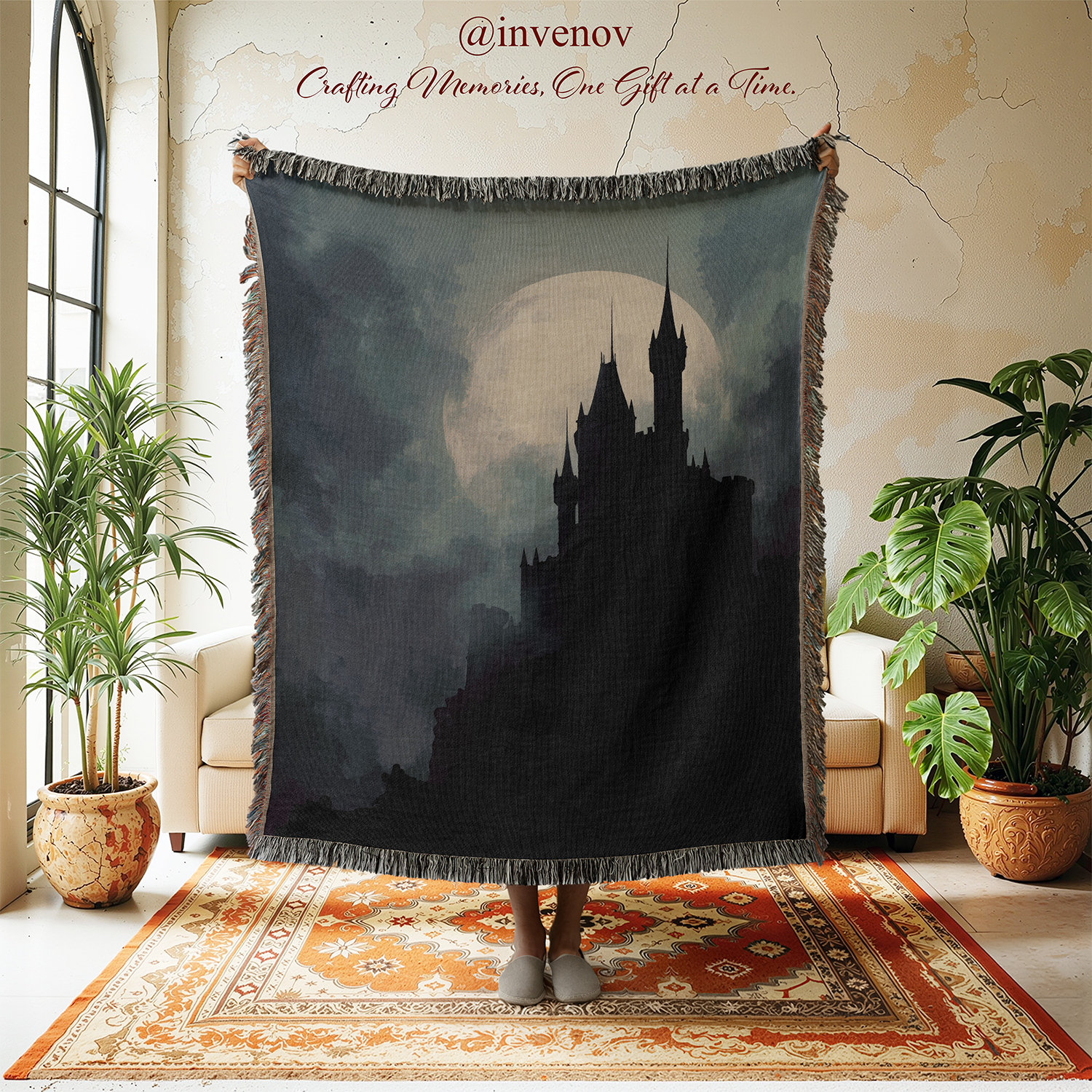 Woven blanket with castle design hanging in a room with plants and furniture.