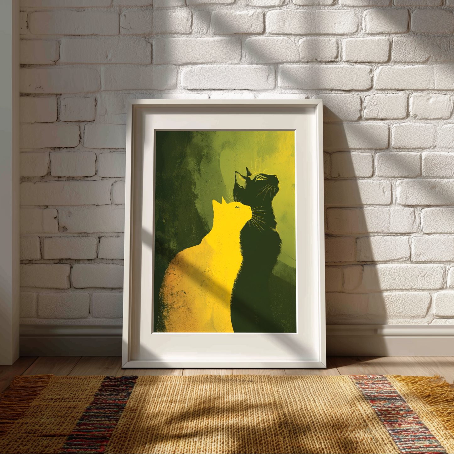 Framed artwork of two cats on a green background against a white brick wall.