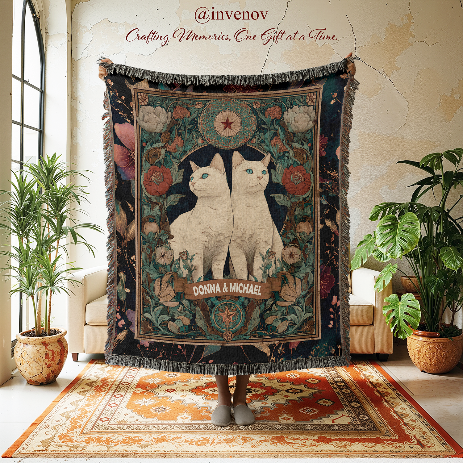 Decorative tapestry with cat design held by a person in a room with plants and furniture.