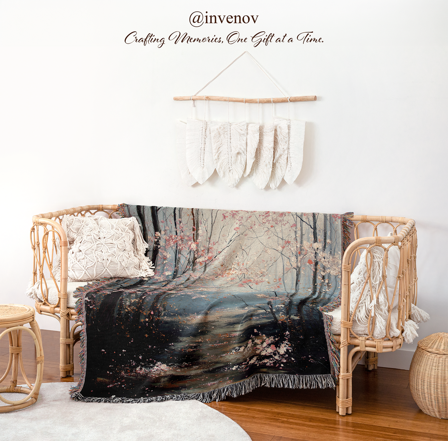 Decorative blanket with nature design draped over a chair in a room with wicker furniture and white walls.