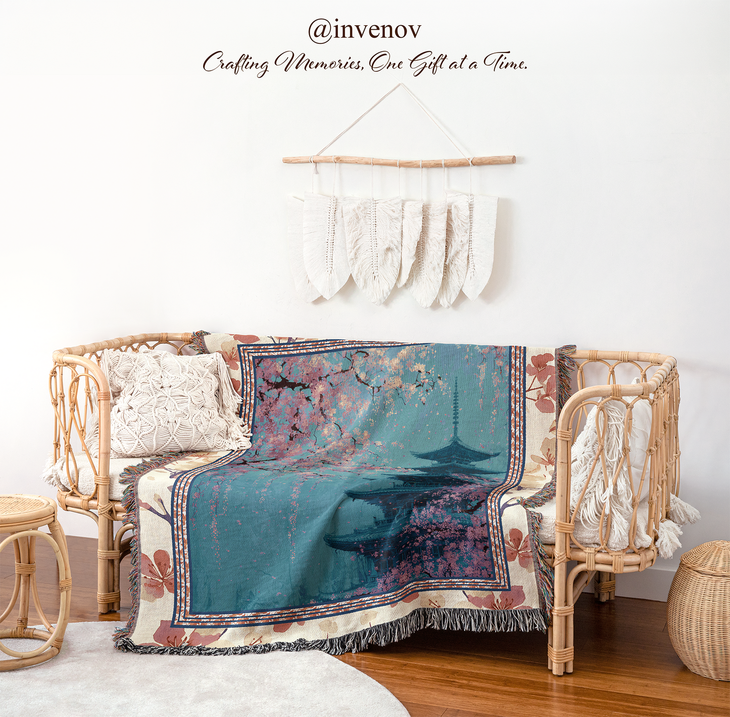 Decorative blanket with floral patterns draped over a wicker chair in a room setting.