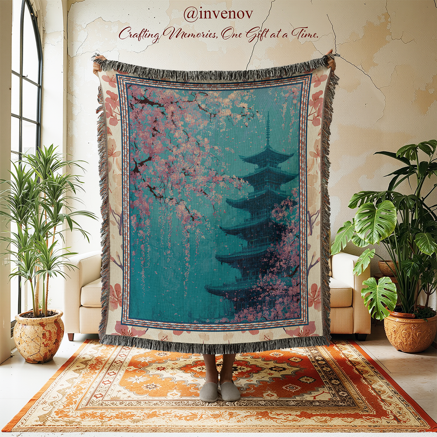 Decorative tapestry with a pagoda design in a room with plants and furniture.