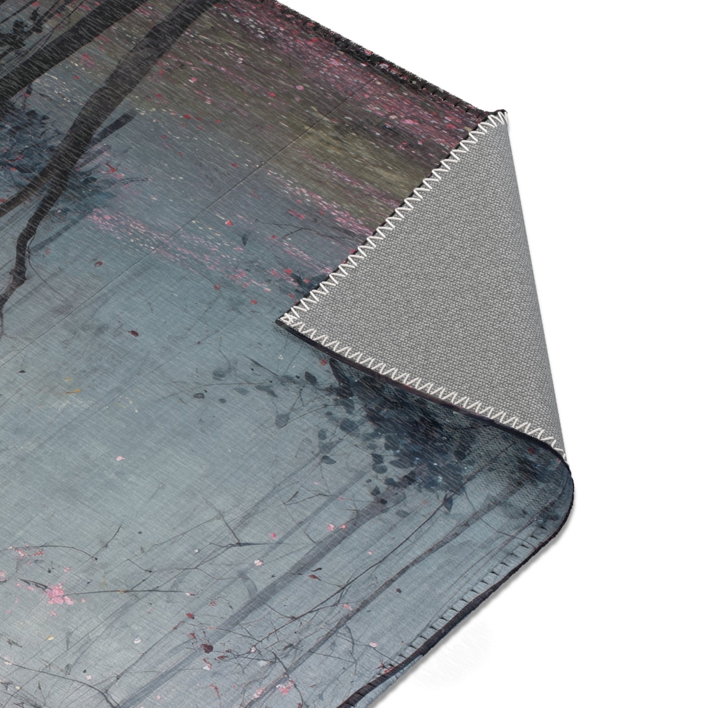 Area Rug with textured surface and brand logo on a white background
