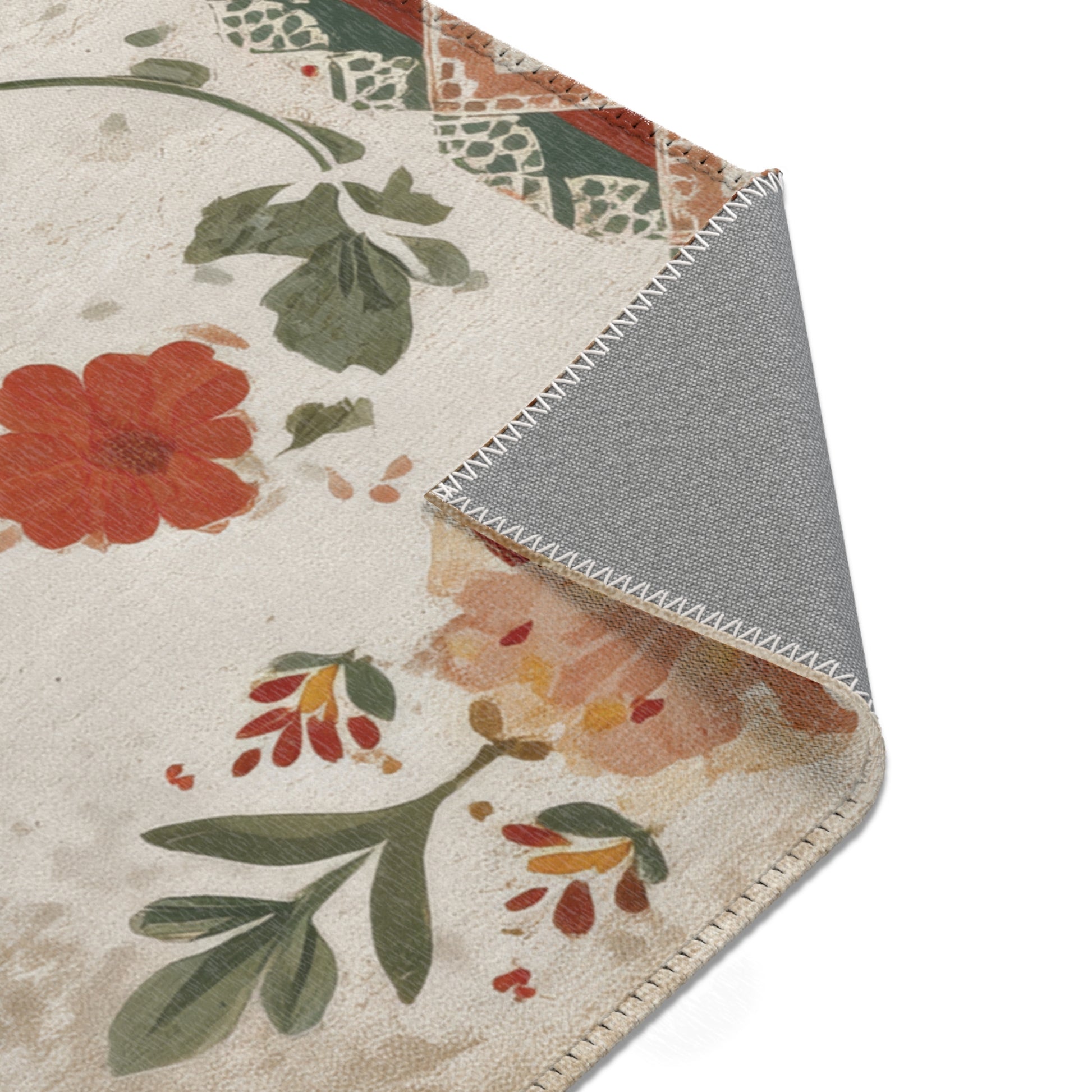 Floral patterned rug with a gray border on a white background