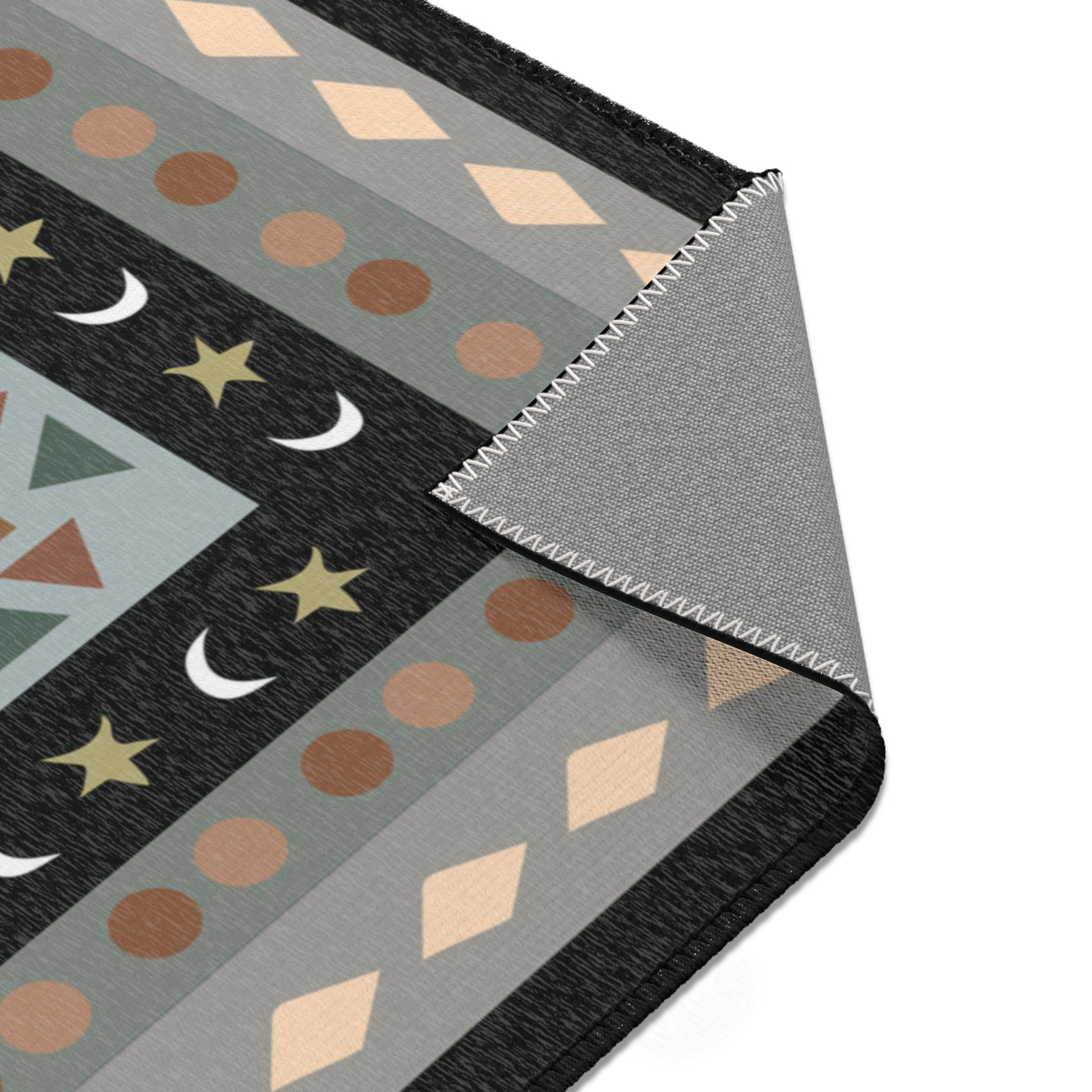 Close-up of a patterned rug with geometric shapes on a white background
