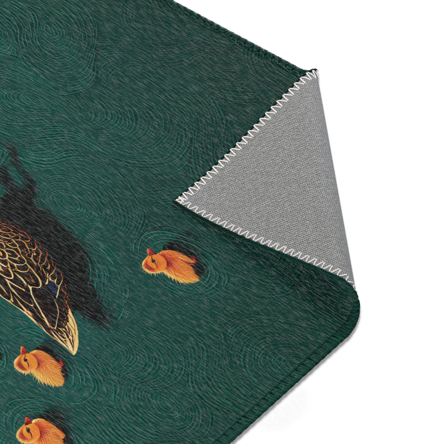 Area rug with ducks and fish design on a green background