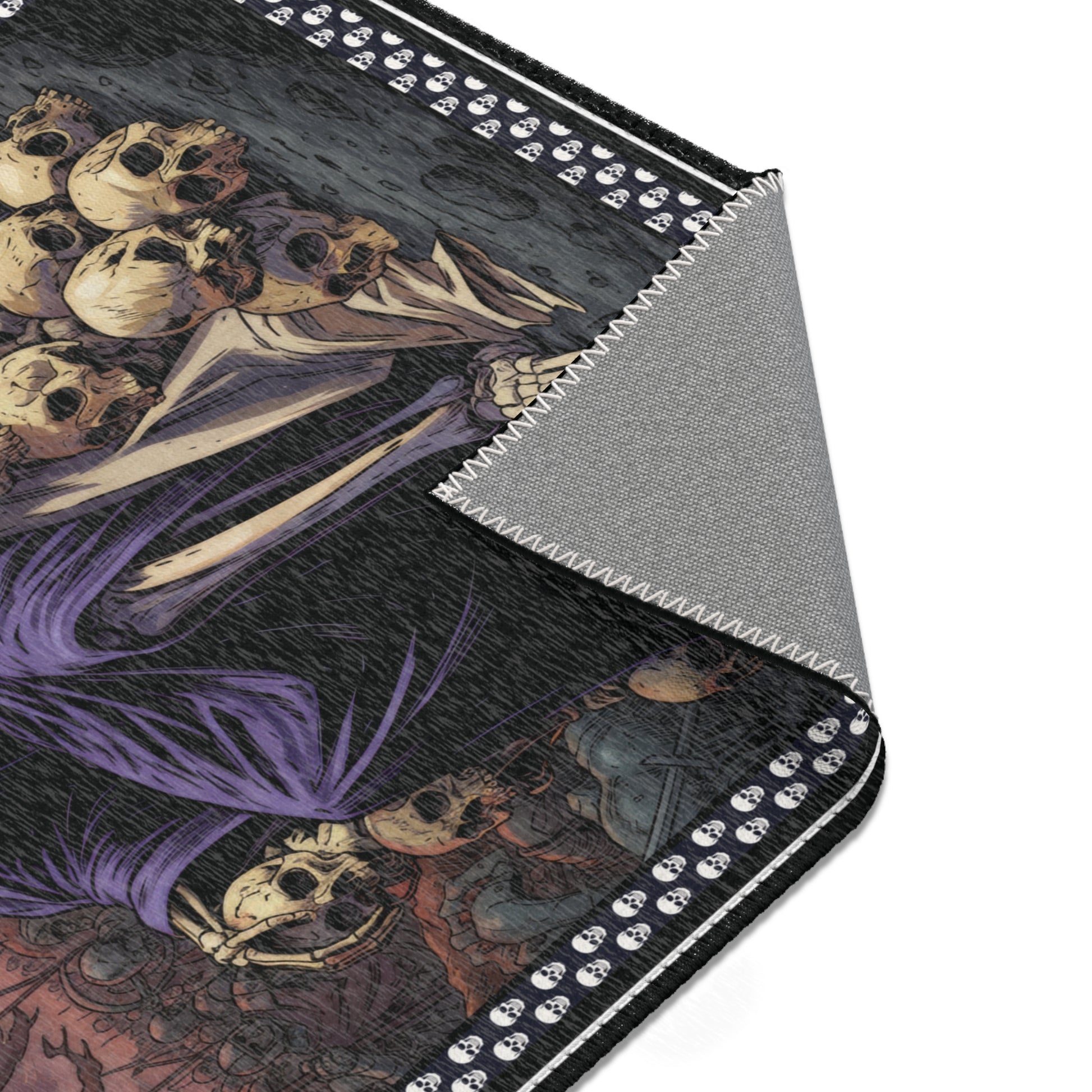 Close up of an area rug with skull and skeleton design on a black background