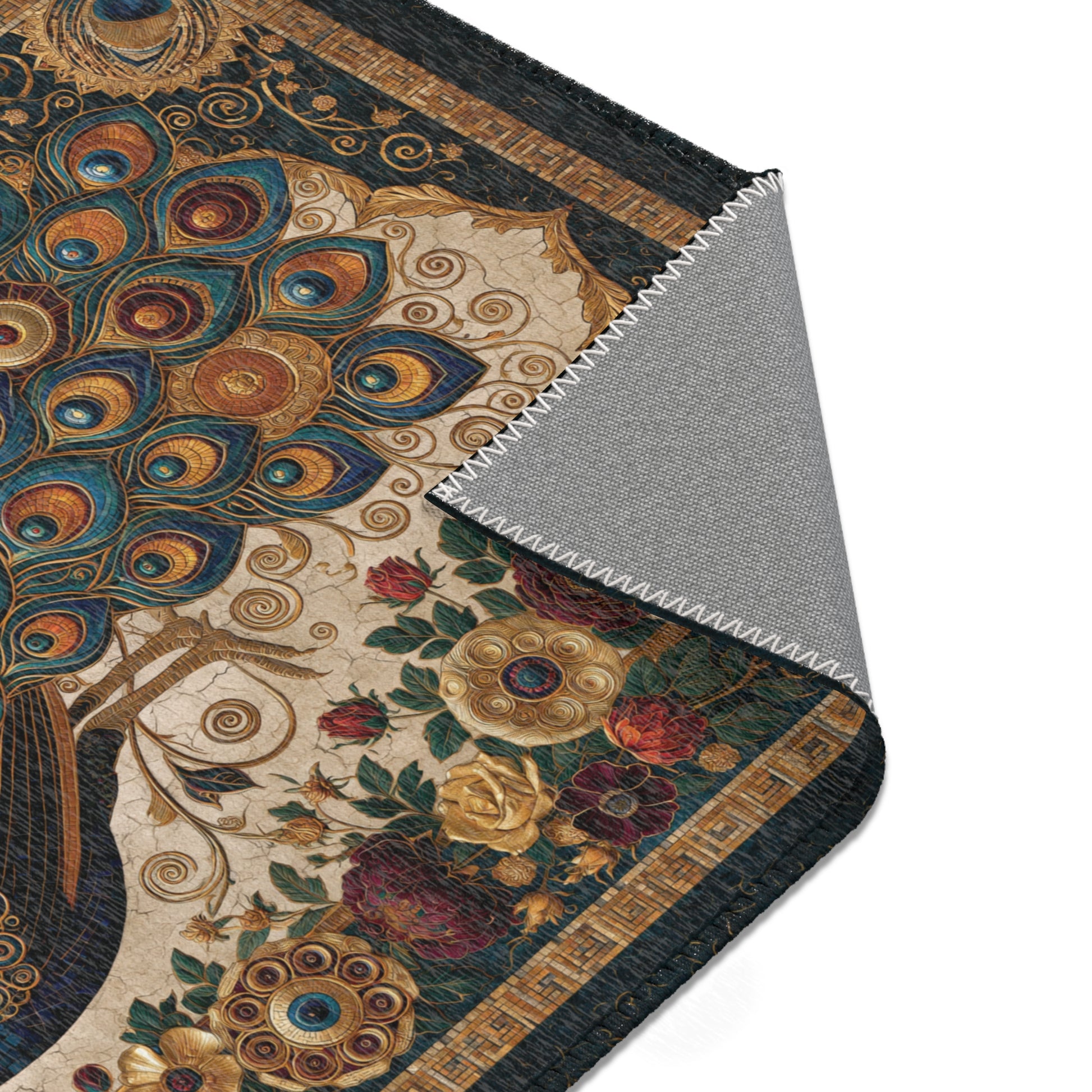 Close-up of an area rug with peacock design and floral elements.