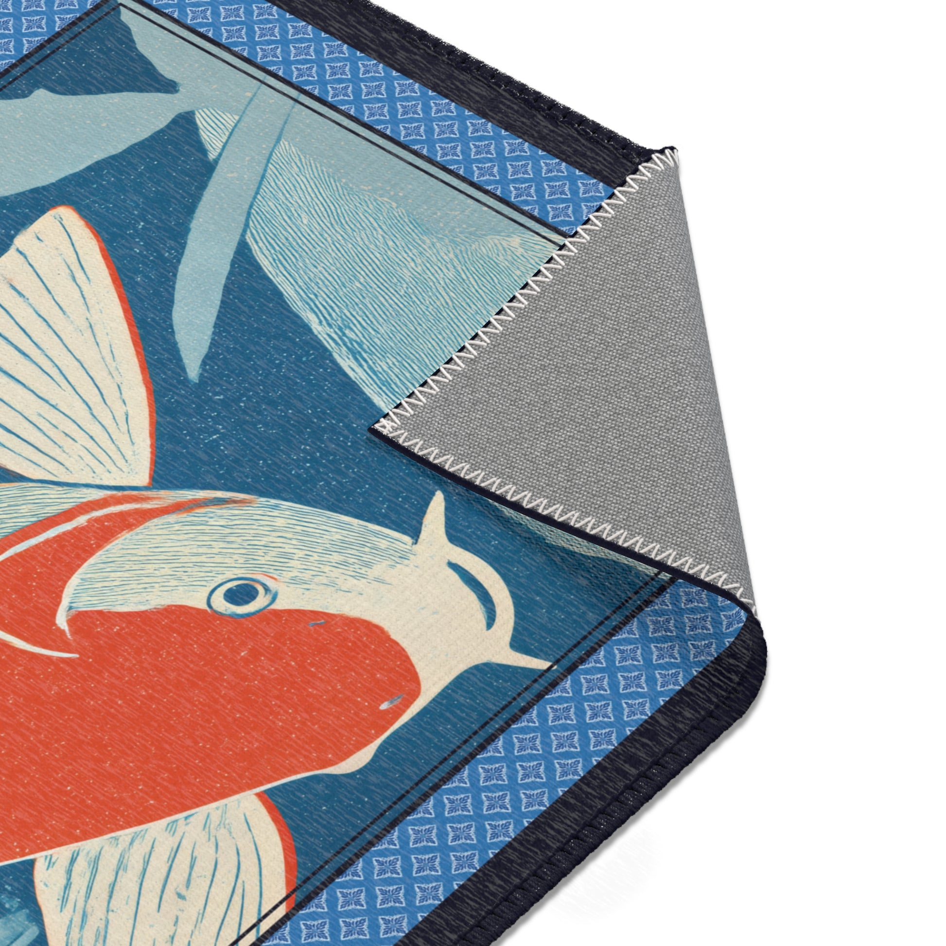 Close-up of an area rug with a fish design on a blue background