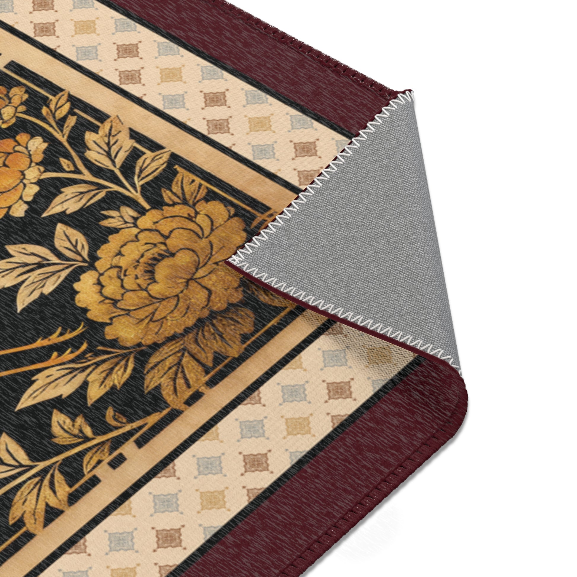 Close-up of area rug with floral and geometric patterns.