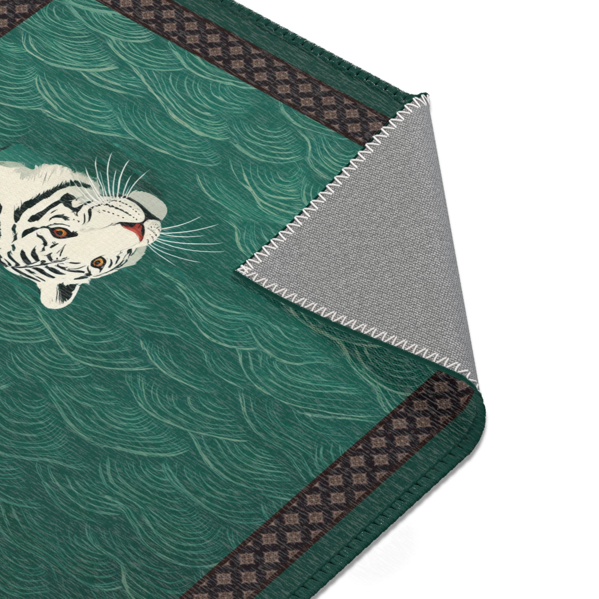 Area rug with a tiger design on a green background