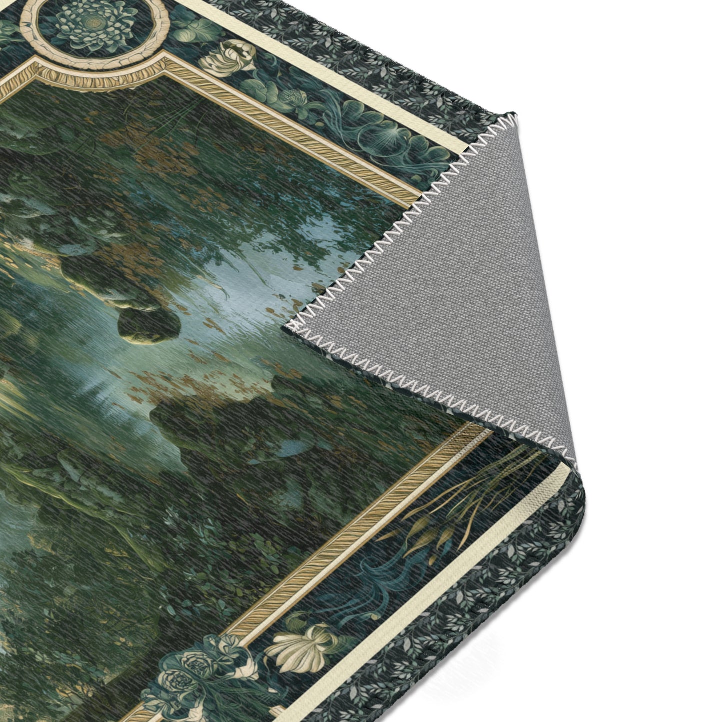 A close-up of a rectangular mat or rug with a dark forest landscape print and ornate beige decorative border, shown with one corner folded back to reveal a gray textured underside.
