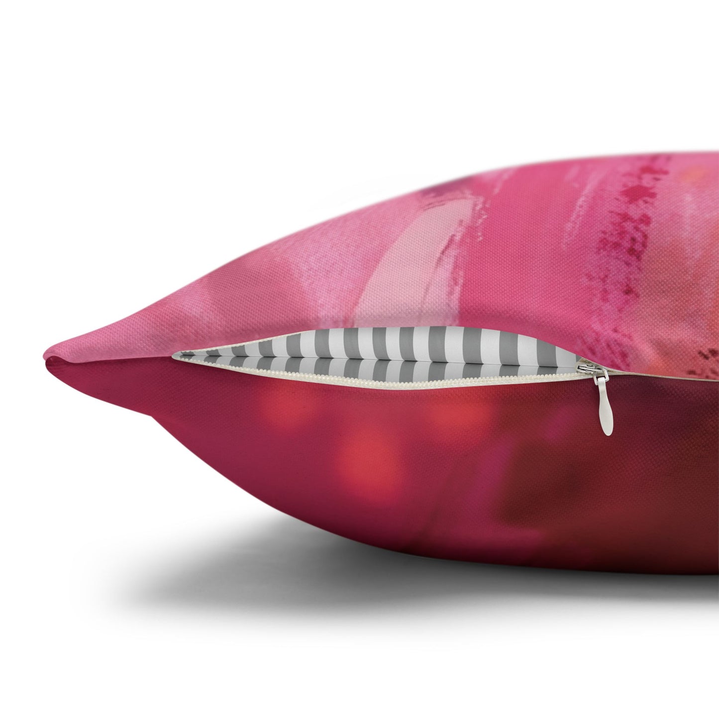Pink pillow with a zipper on a white background