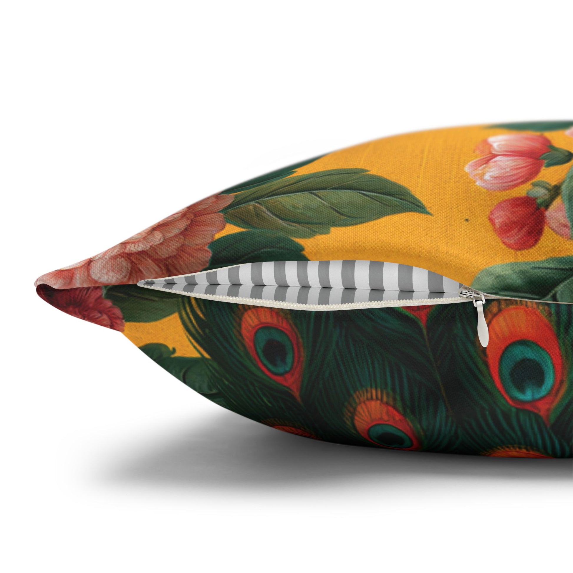 Decorative pillow with peacock feather and floral design on a white background