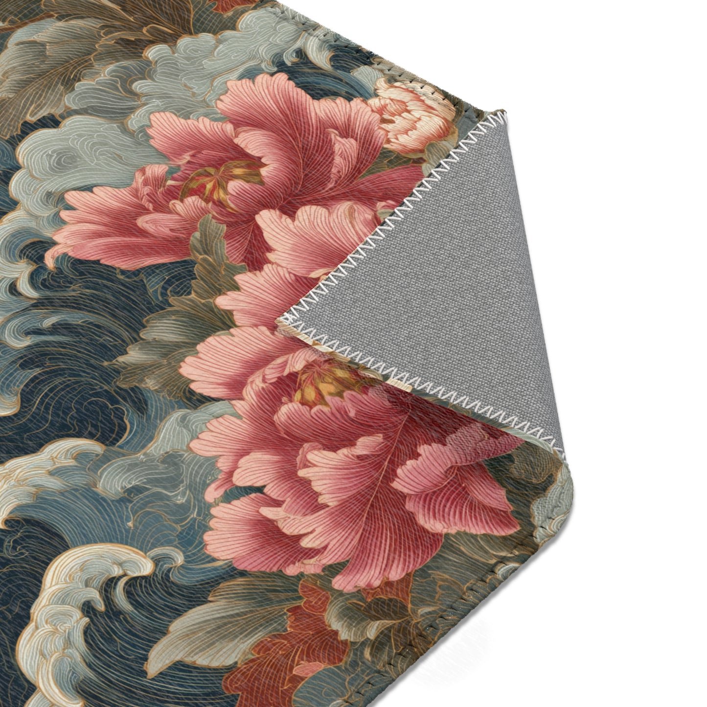 Close-up of a floral patterned rug with pink flowers and wavy lines on a gray background.