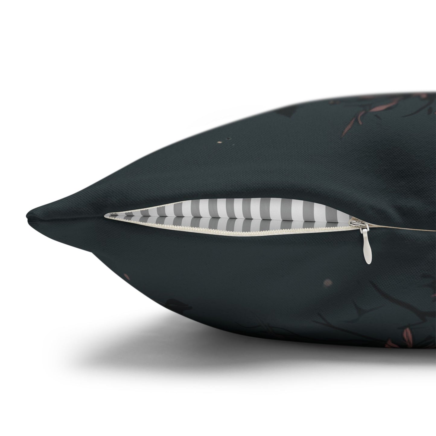 Black pillow with a zipper opening to reveal a striped interior on a white background
