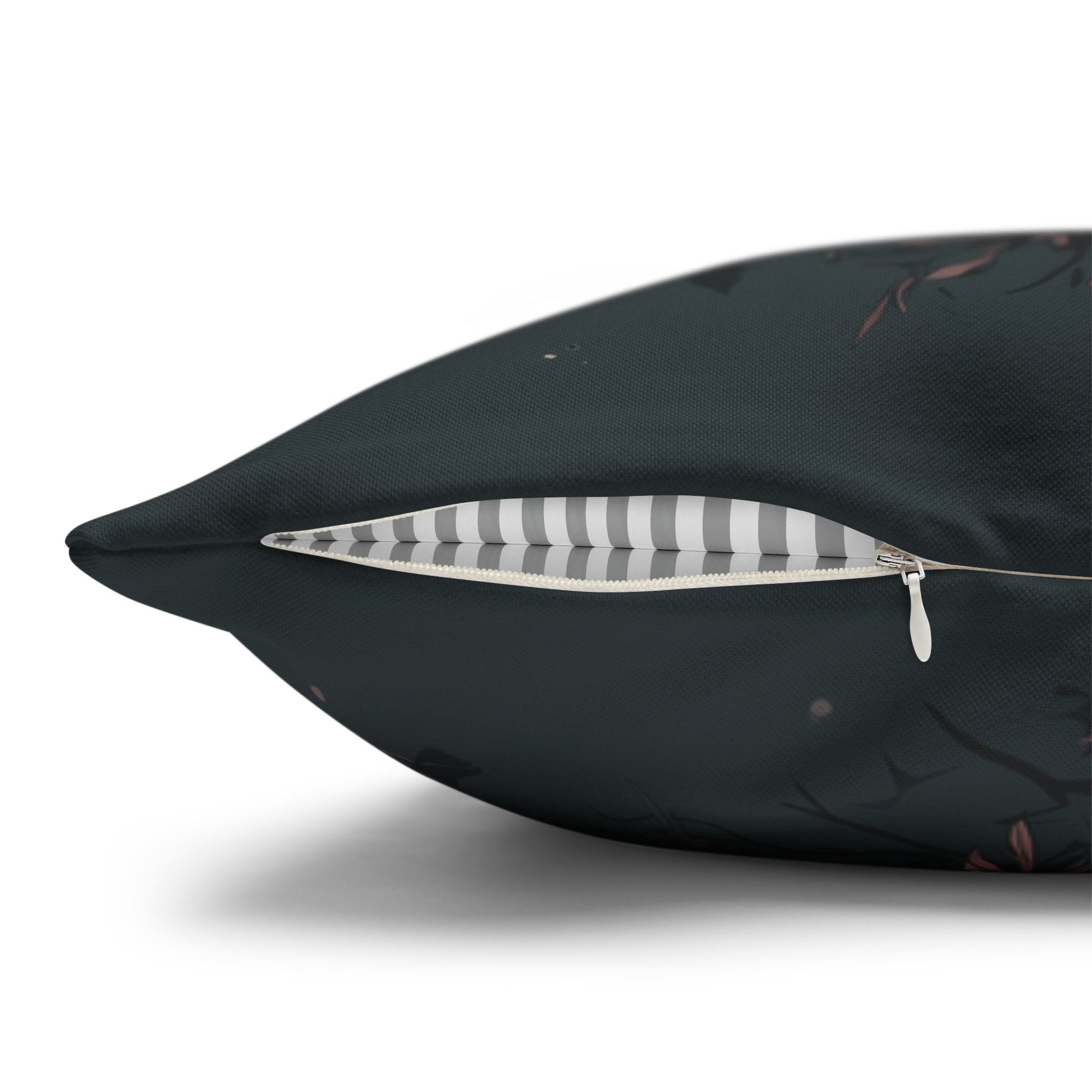 Black pillow with a zipper opening to reveal a striped interior on a white background