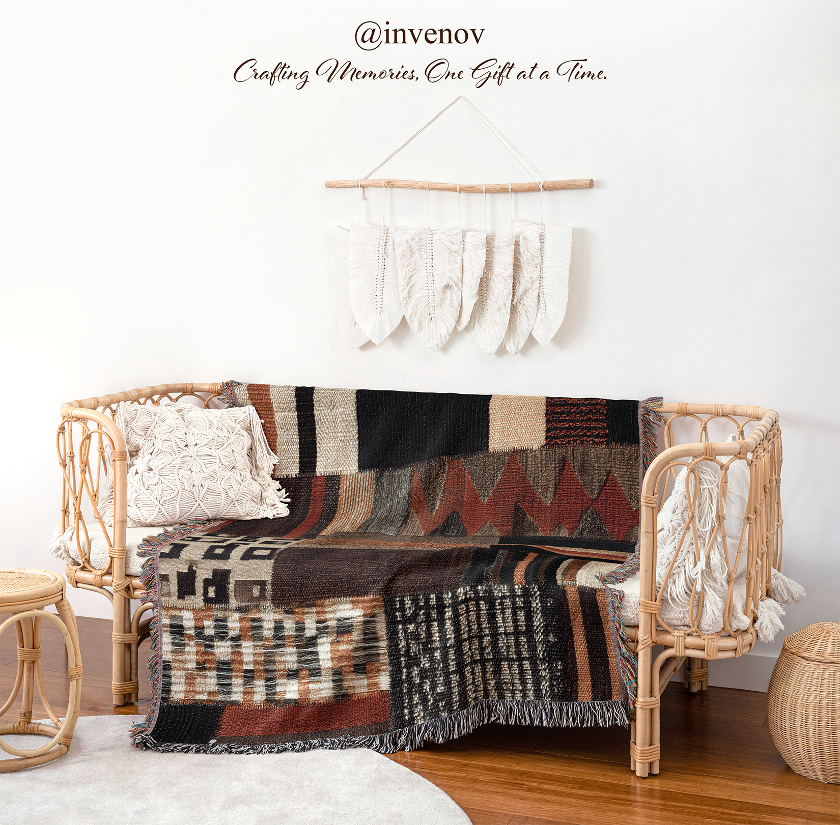 A bohemian-style rattan loveseat sofa with a multicolor geometric patterned throw blanket draped over it, styled in a room setting with a white wall, decorative wall hanging, wooden floor, and side tables.