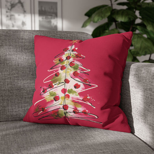 A square pink throw pillow featuring a watercolor-style Christmas tree design with red ornaments, green leaves, and a gold star 