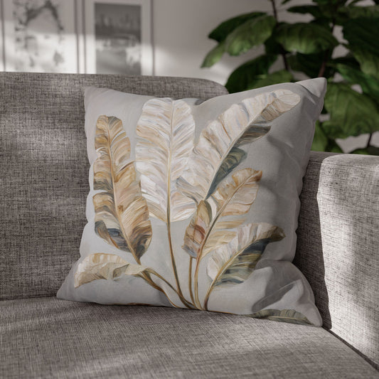 Decorative pillow with leaf pattern on a gray sofa
