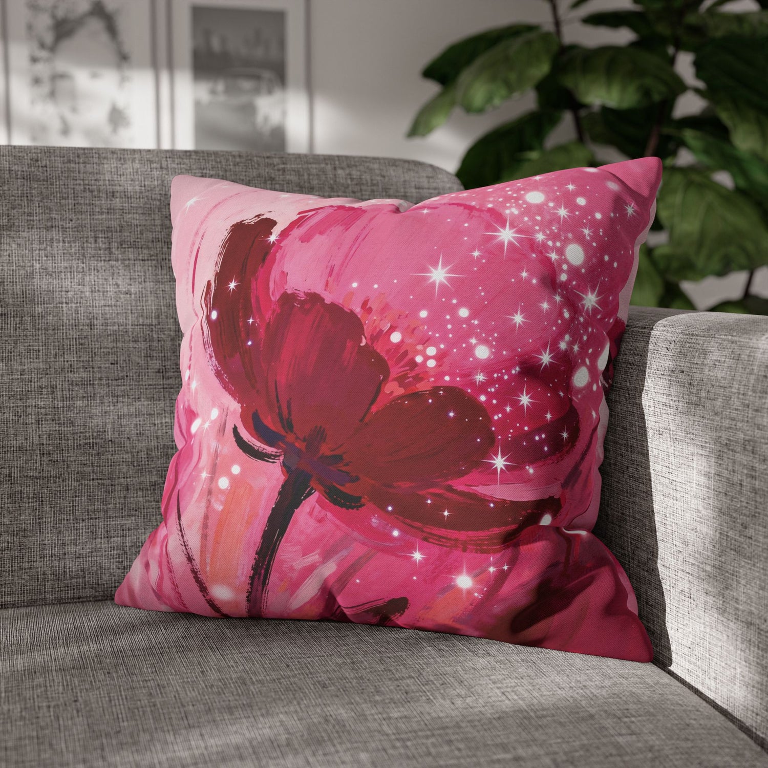 Pink pillow with a red floral design on a gray couch