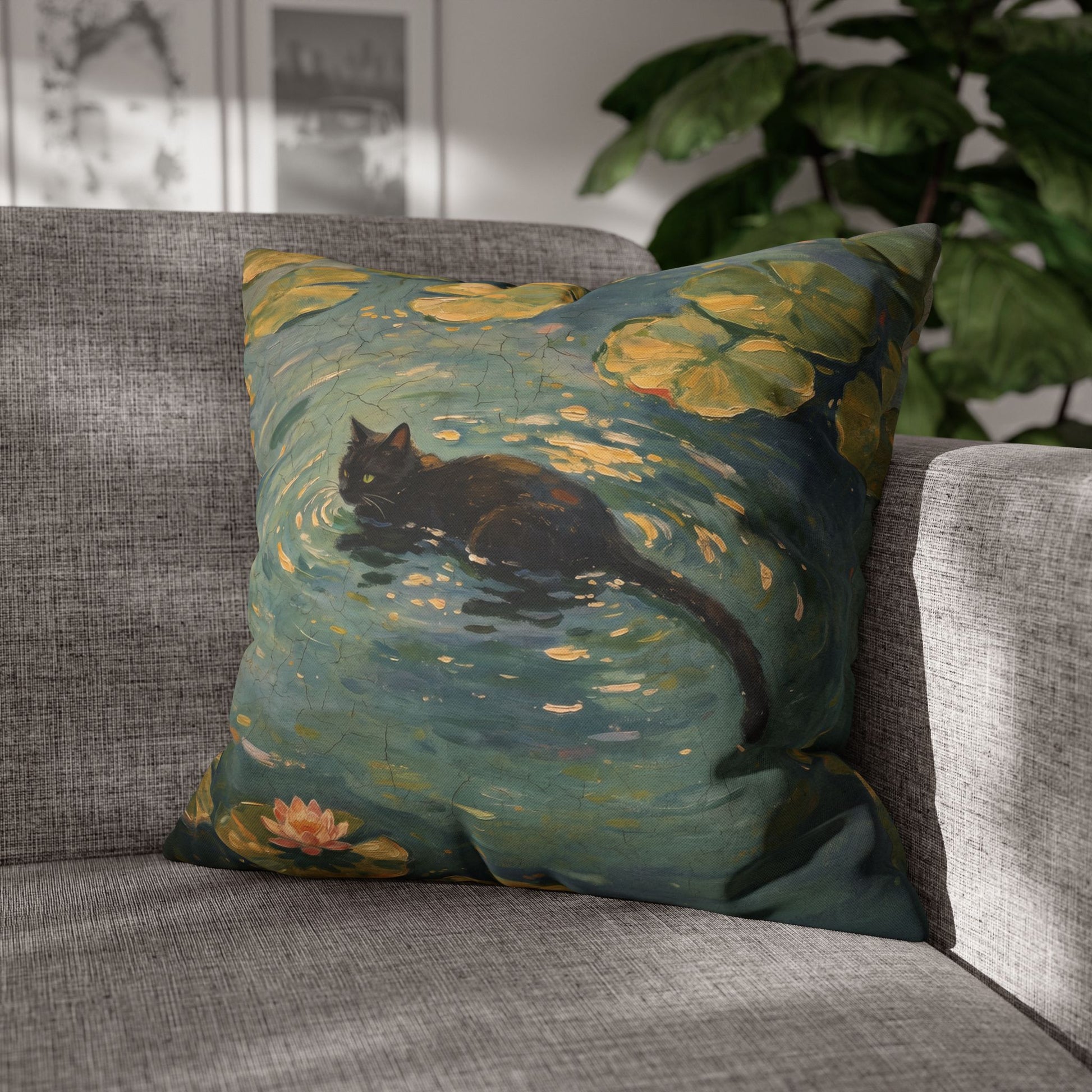 Decorative pillow with a cat and lily pads design on a gray sofa.