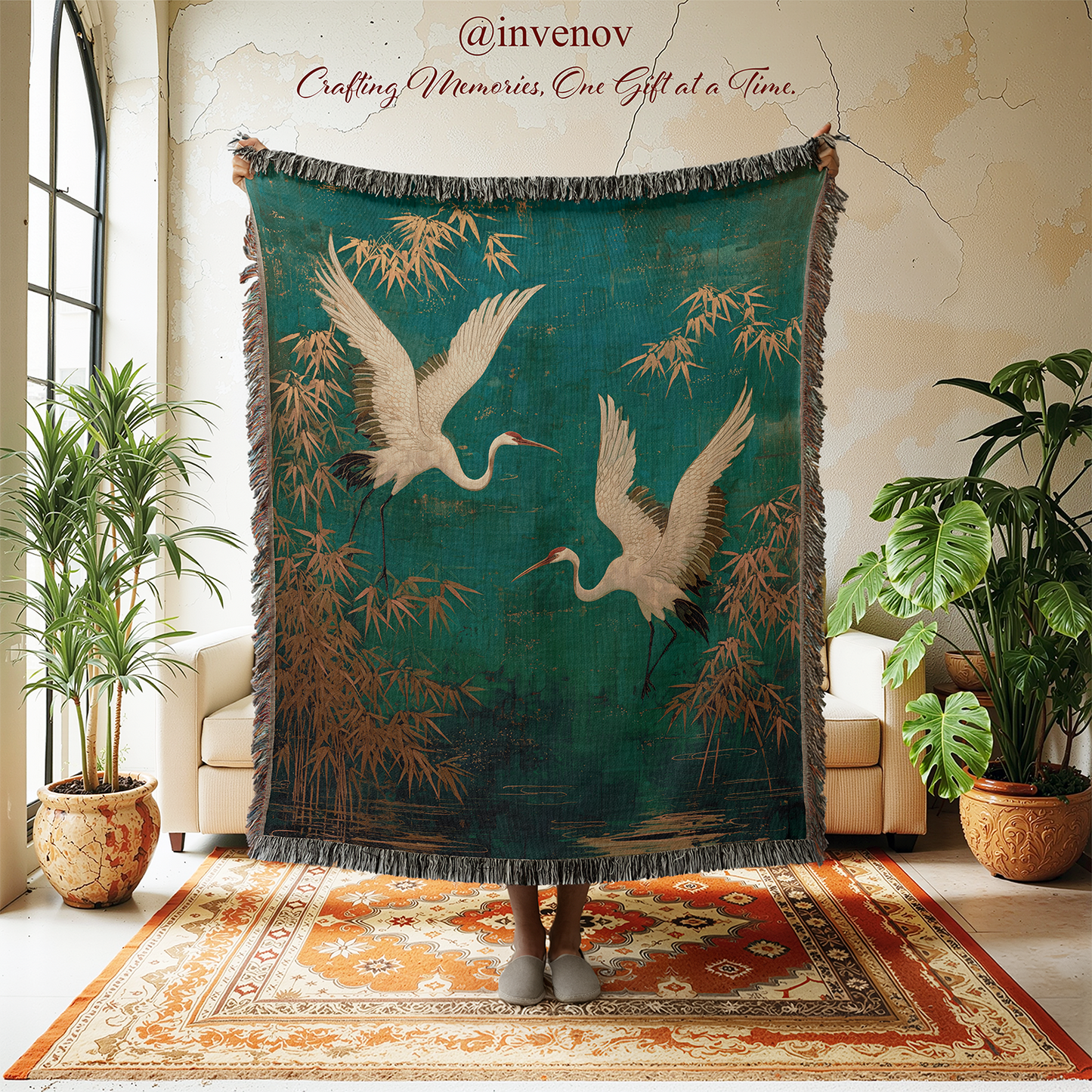 Decorative blanket with crane design in a room with plants and furniture.