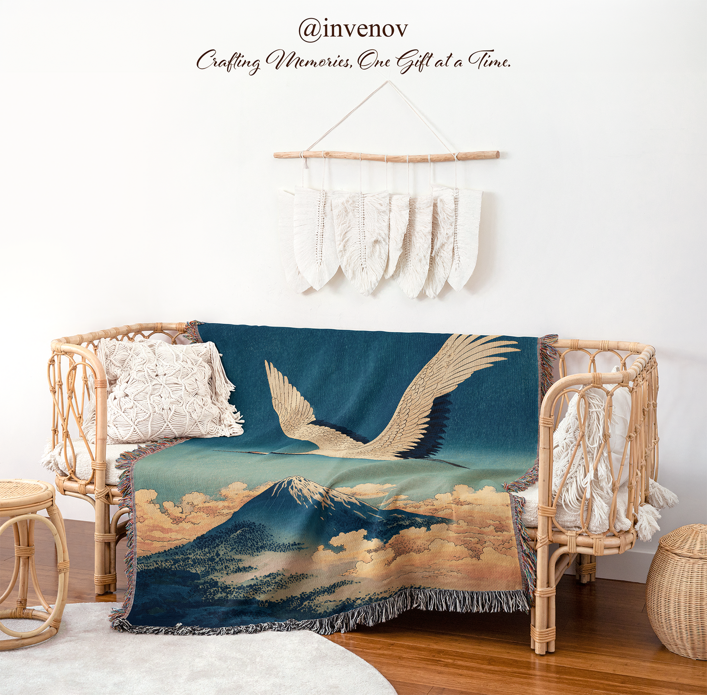 Decorative blanket with a mountain and bird design on a wicker chair