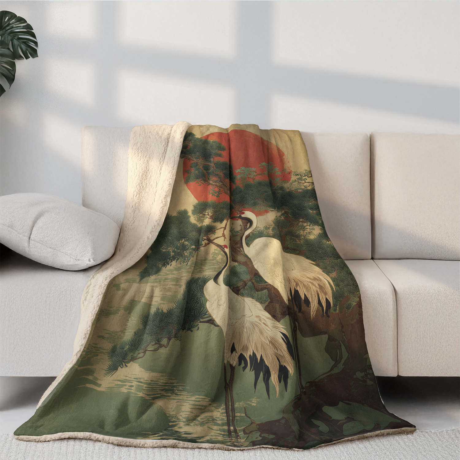 Decorative blanket with nature design draped over a sofa in a living room.
