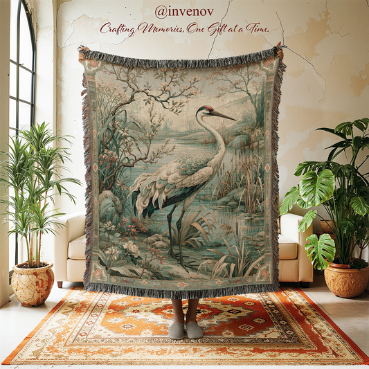 A large woven tapestry featuring a heron in a marsh landscape, held up in a styled room with potted plants, a cream sofa, and a patterned rug.