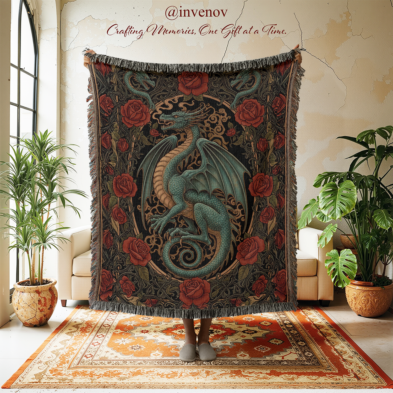 Decorative dragon and rose patterned blanket held by a person in a room with plants and furniture.