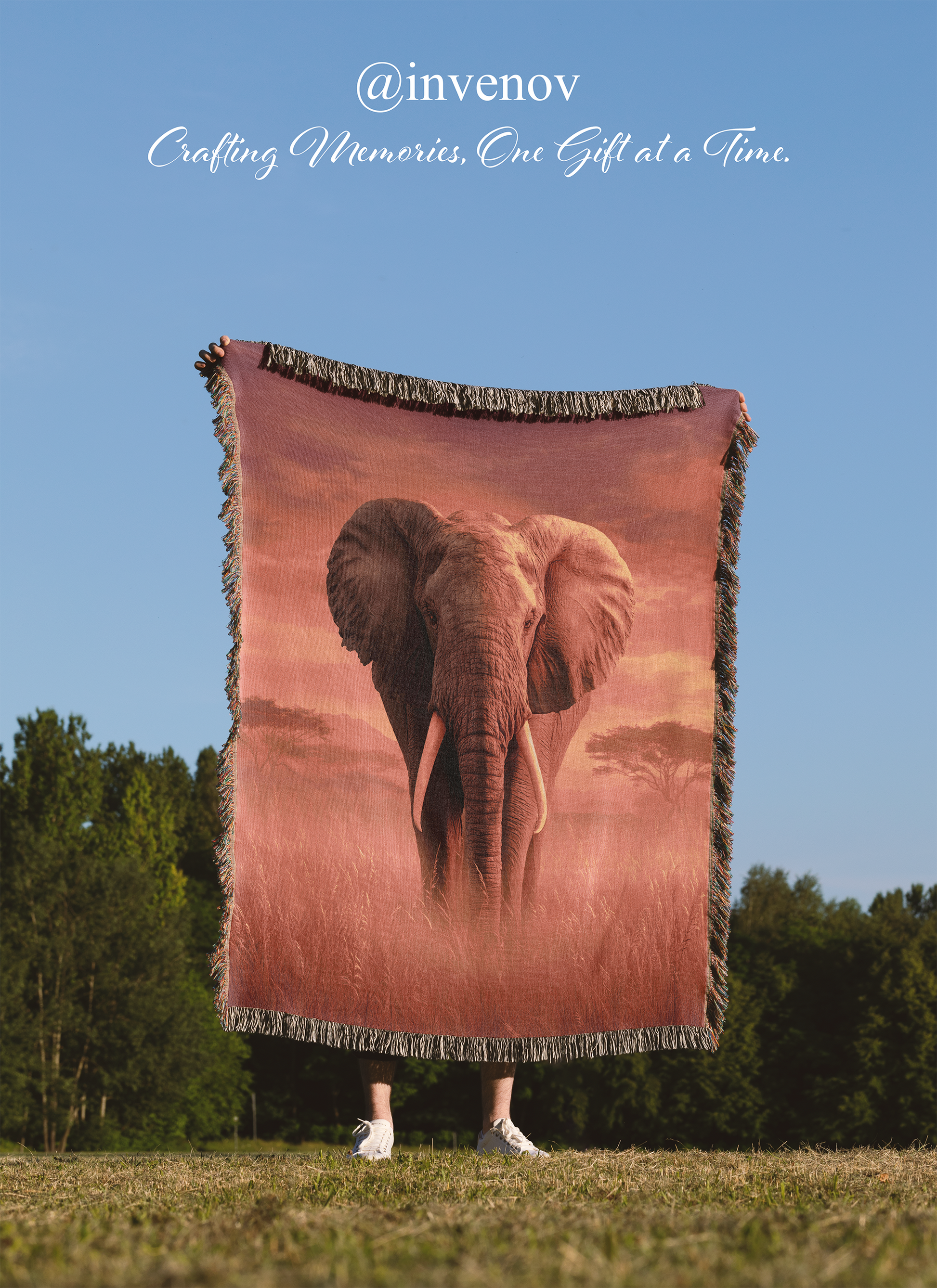Person holding a blanket with an elephant design outdoors