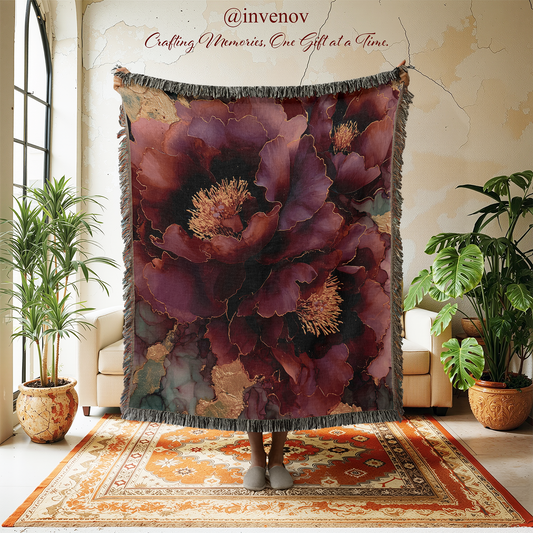 Floral patterned throw blanket displayed in a room with plants and furniture.