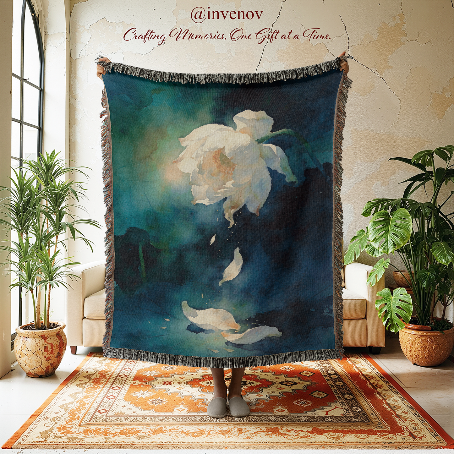 Decorative throw blanket with floral design in a room with plants and furniture.