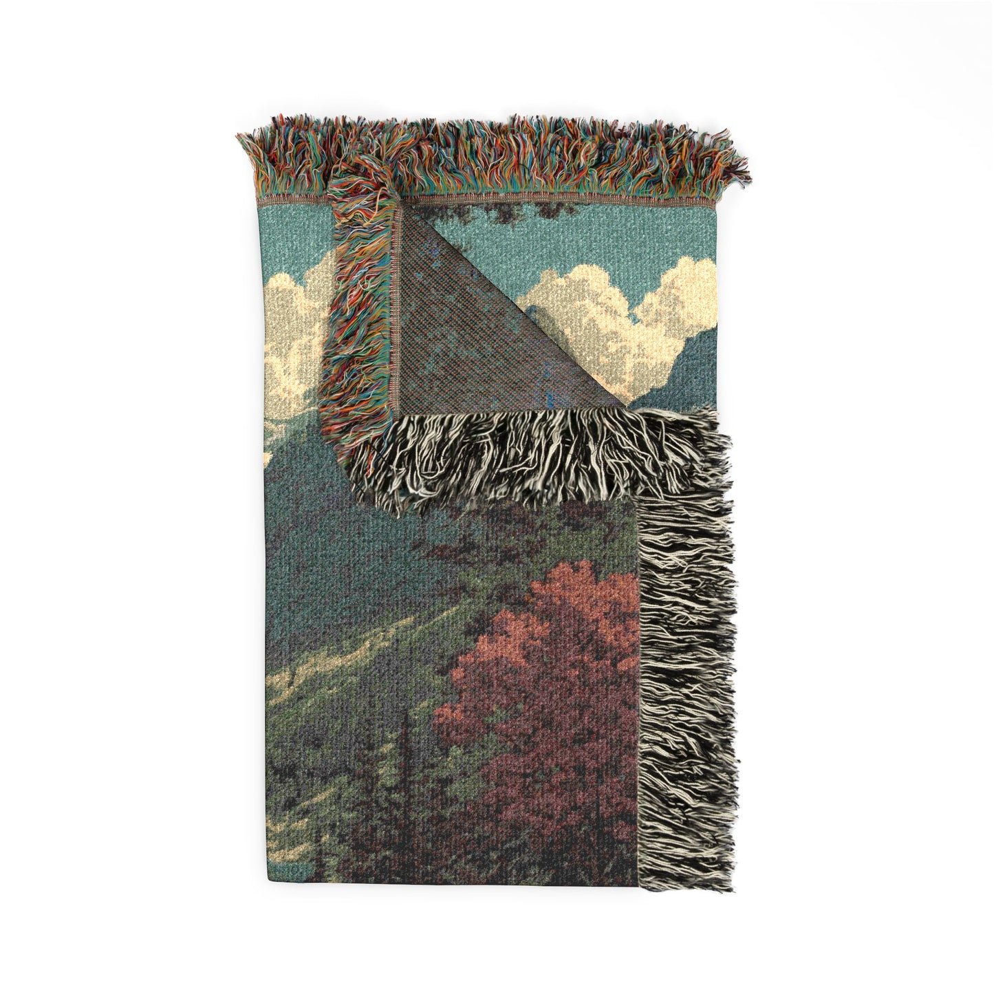 Blanket with landscape design featuring trees and sky on a white background