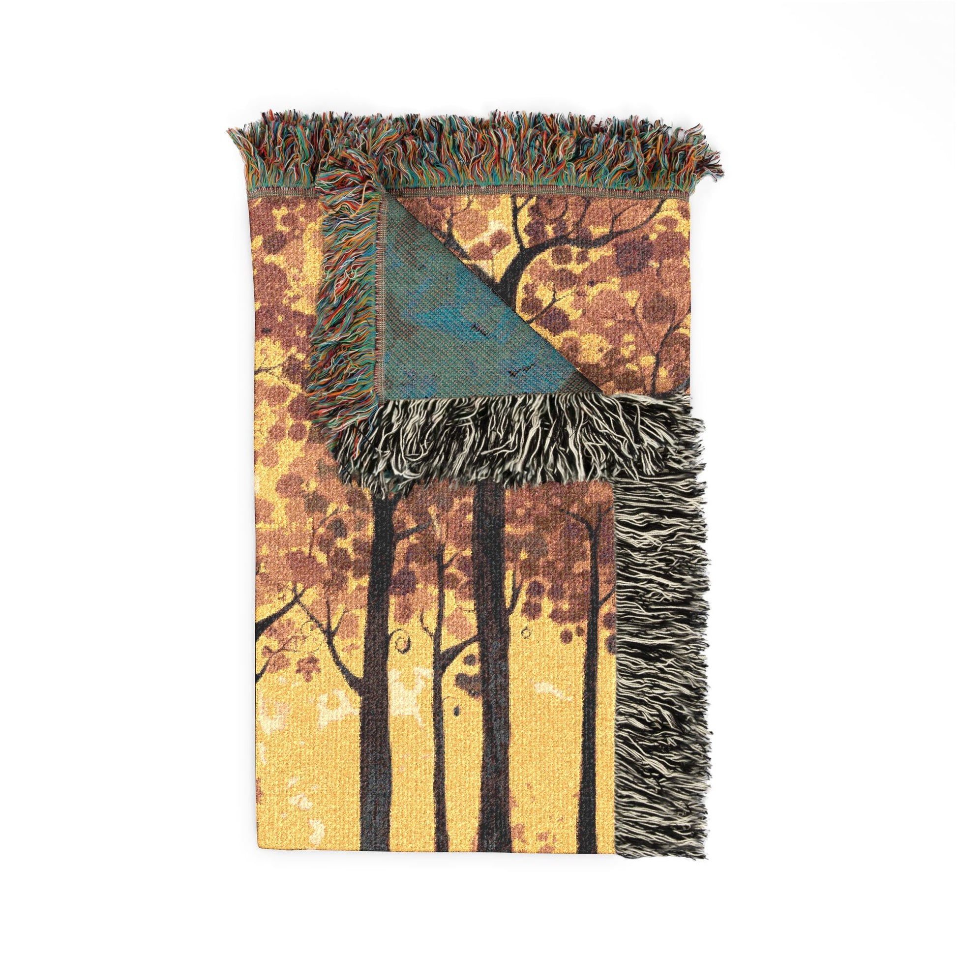 Blanket with forest design and fringed edges on a white background