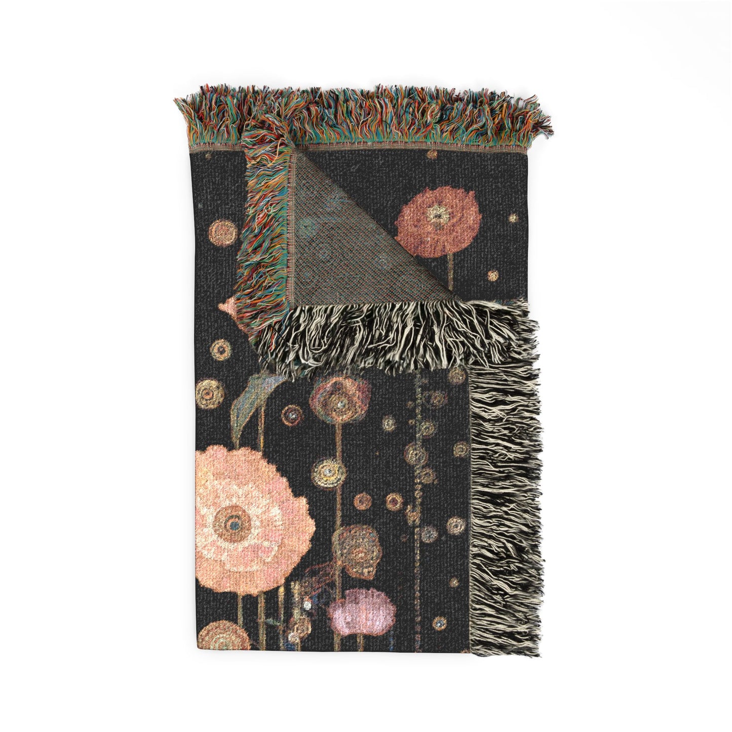 Decorative blanket with floral patterns and fringed edges on a white background
