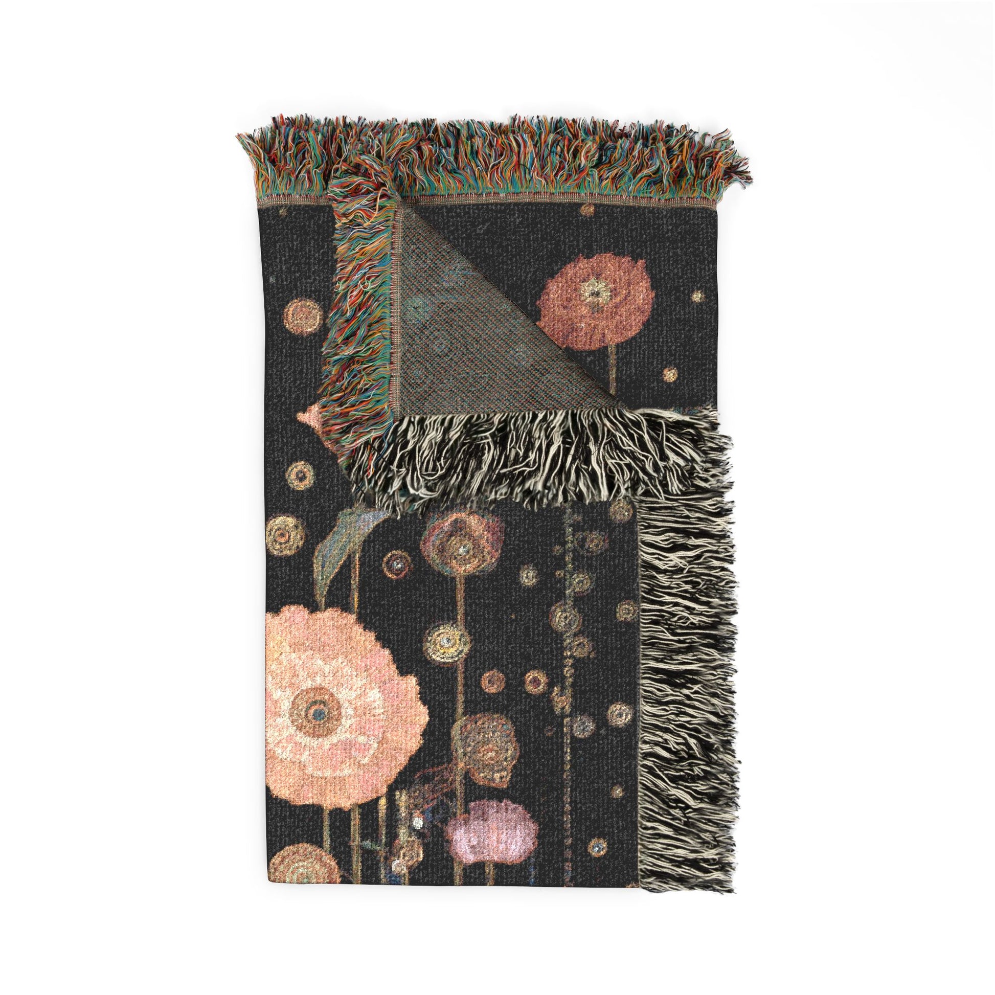 Decorative blanket with floral patterns and fringed edges on a white background