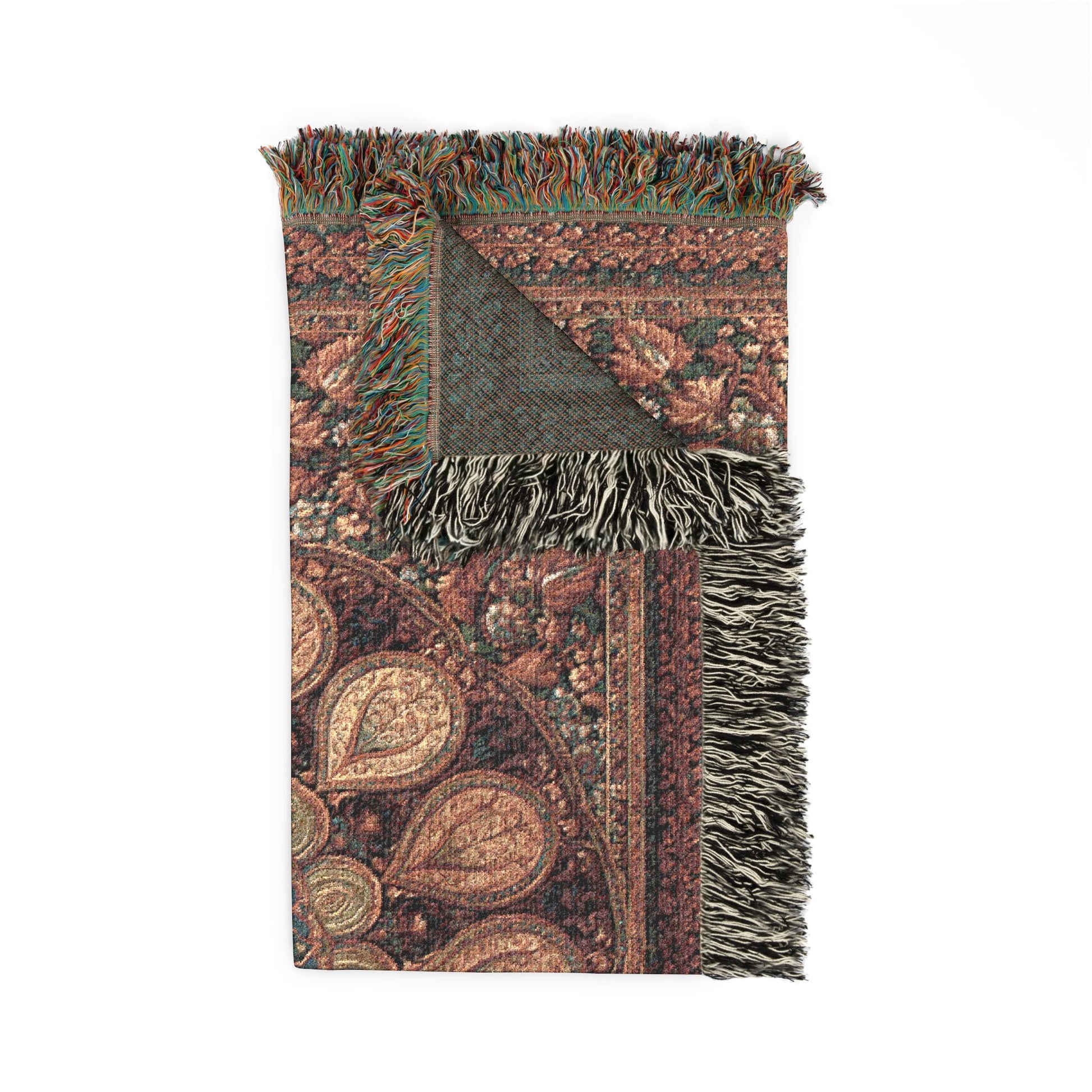 Decorative throw blanket with intricate patterns and fringes on a white background