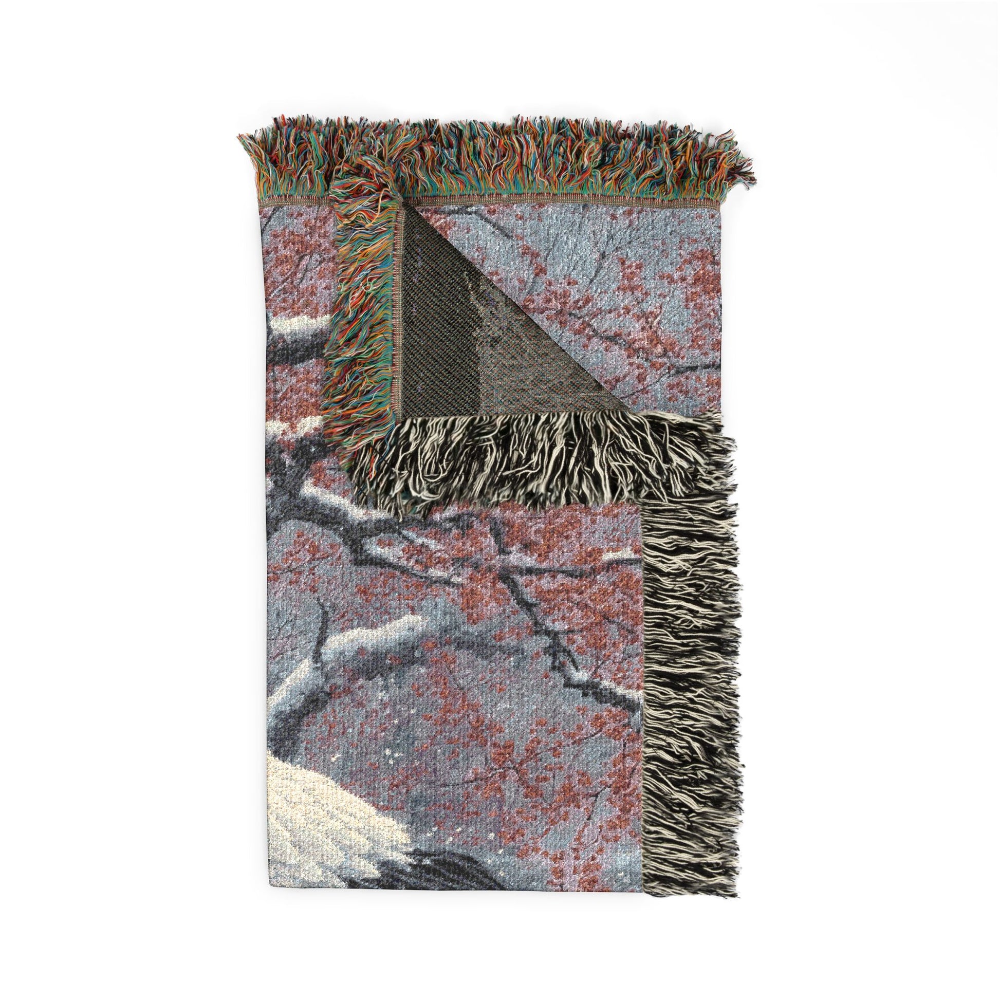 Textured blanket with geometric pattern and fringes on a white background